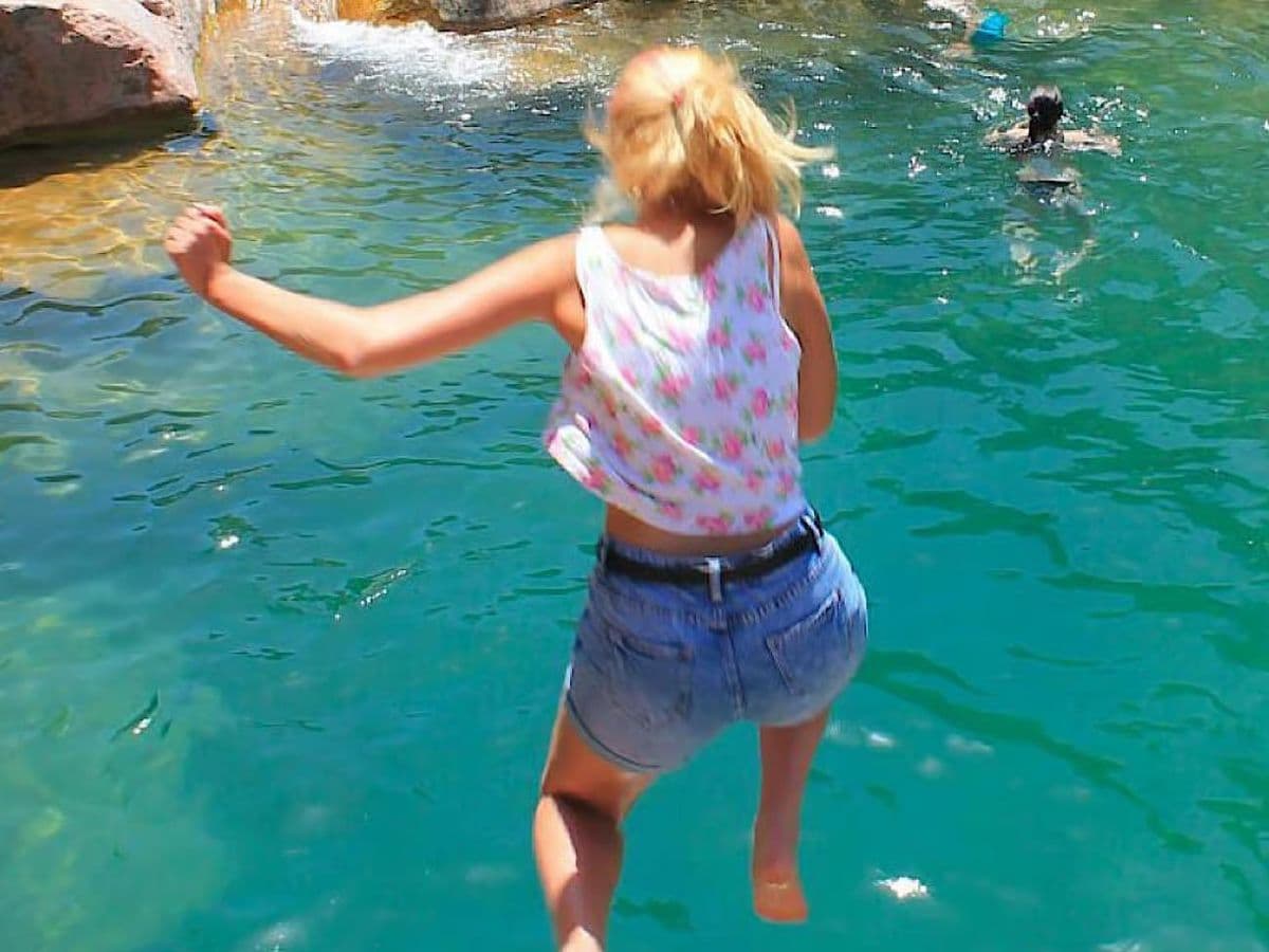 Hiking trail through Paradise Valley gorge with palm trees and clear rock pools near Agadir